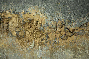 Abstract textured painting featuring a dynamic blend of grey, white, and gold hues with a unique textured surface.