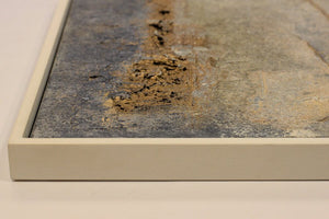 Close-up of framed Traces of Time abstract textured painting by Edelgard Schroer, featuring grey, white, and gold hues.